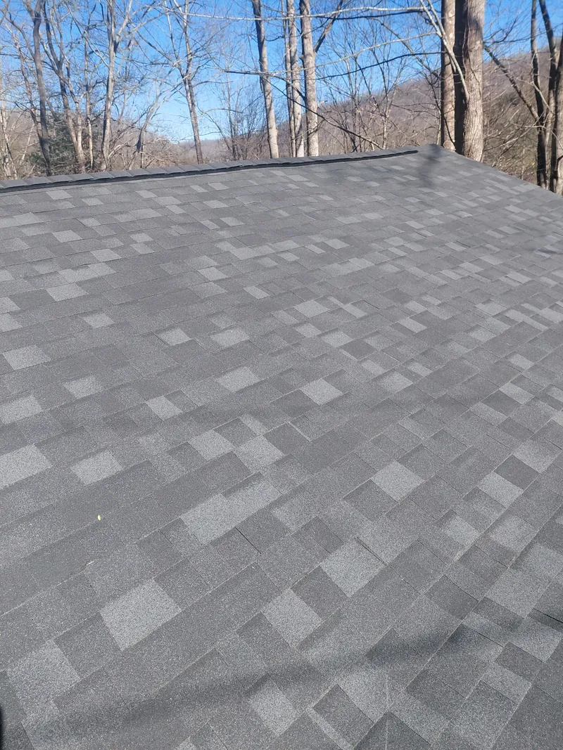 Close-up of gray architectural shingles on a completed roof slope